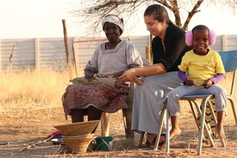 A Pitzer student weaves a basket while studying abroad